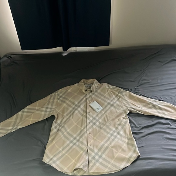 I am selling the burberry check cotton shirt never worn